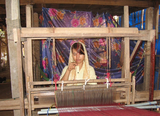 Muslim woman weaving cloth